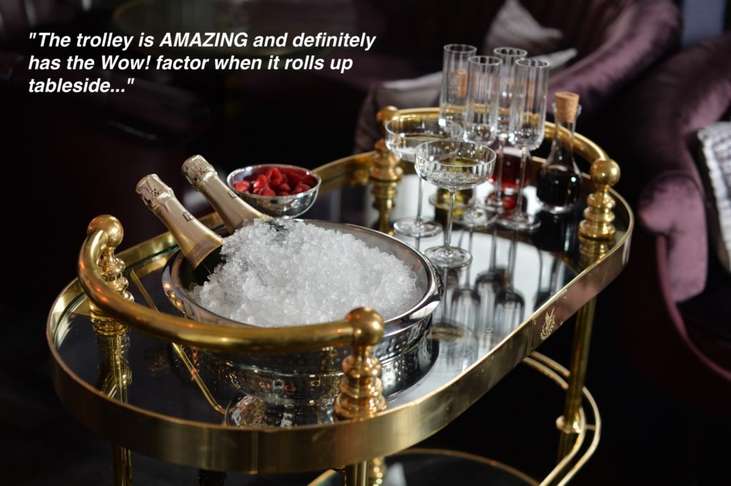 A custom made polished brass champagne trolley with a double-skinned stainless steel ice bowl.