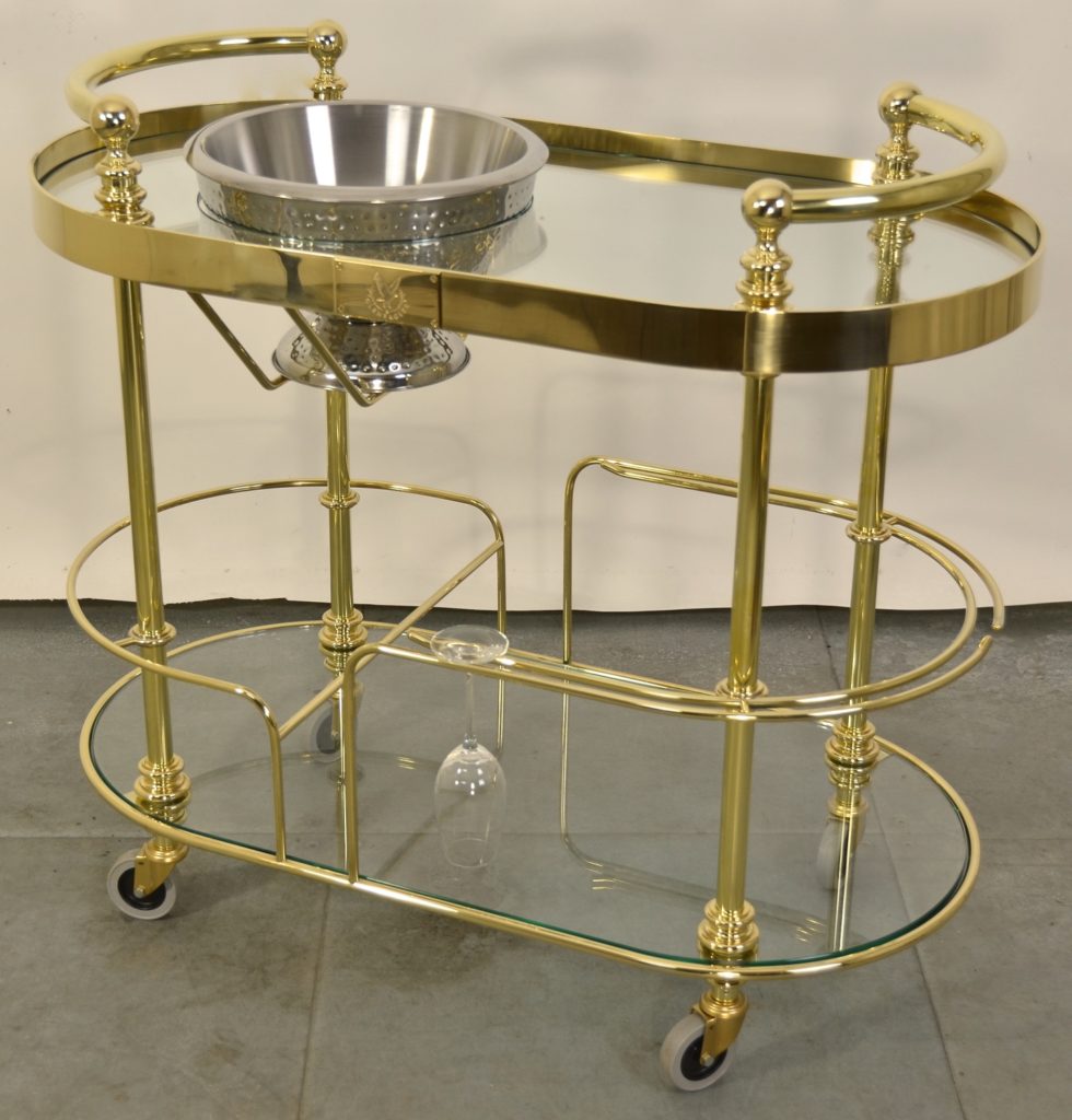 A custom made polished brass champagne trolley with glass shelves and a double-skinned stainless steel ice bowl.