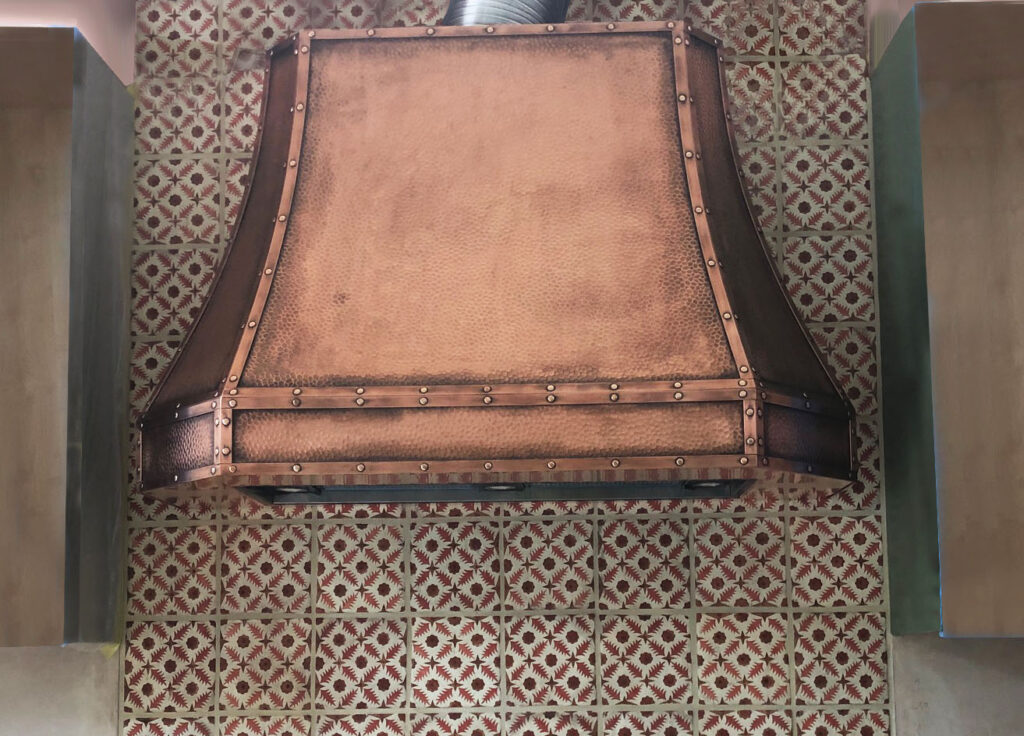 Custom-made patinated copper cooker hood