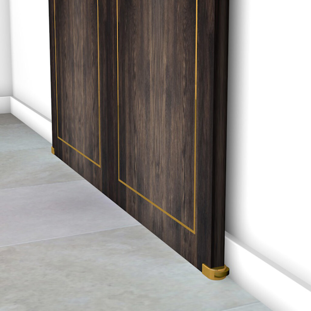 Close-up of a dark wooden sliding door with gold trim, partially open against a light gray tiled floor and white wall. The door is mounted on small, elegant Sliding Door and Panel Wall Guides in brass at the base.