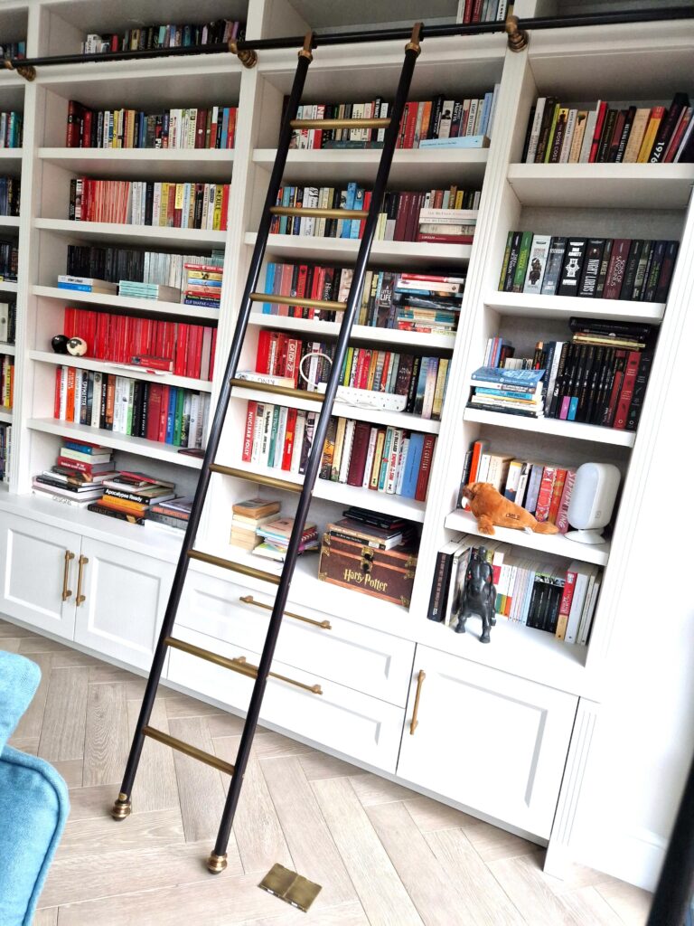 Brass and steel hook on ladder for a library