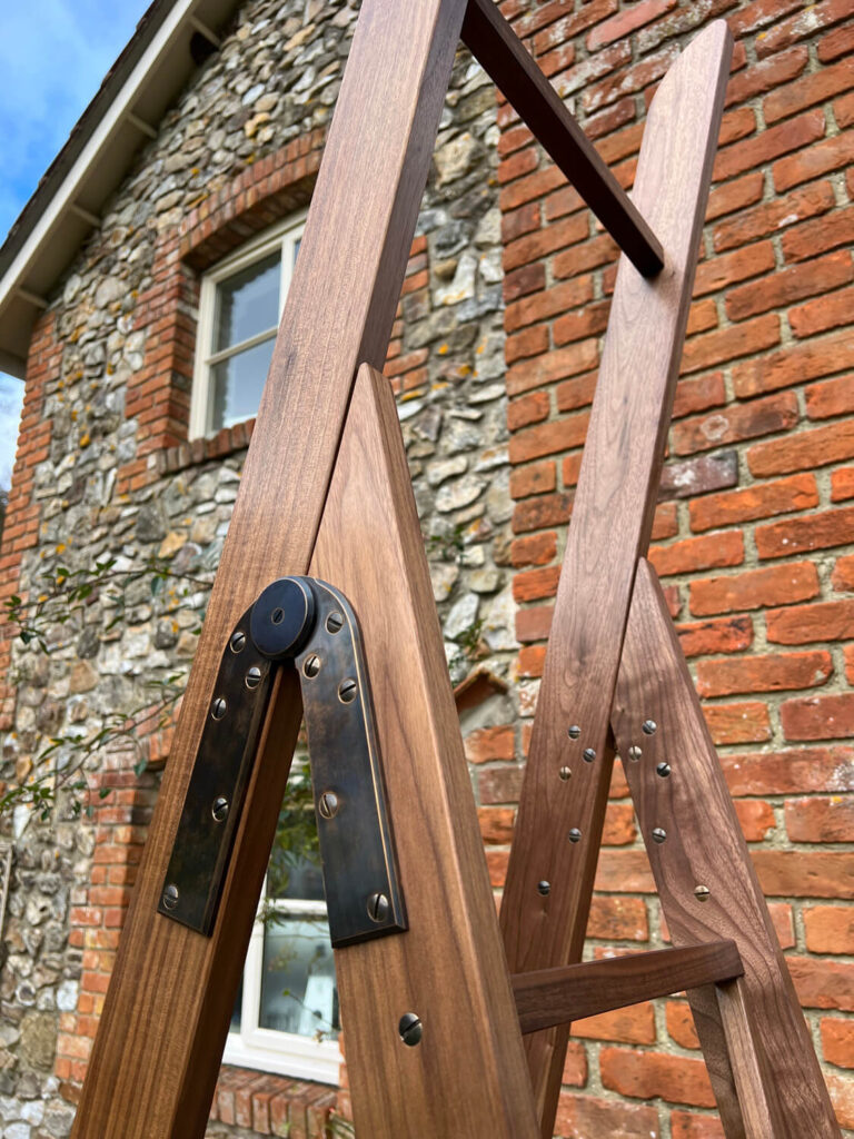 A brass hinge on a bespoke folding ladder