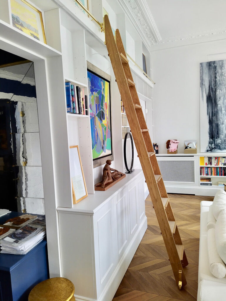 A hand made wooden rolling library ladder